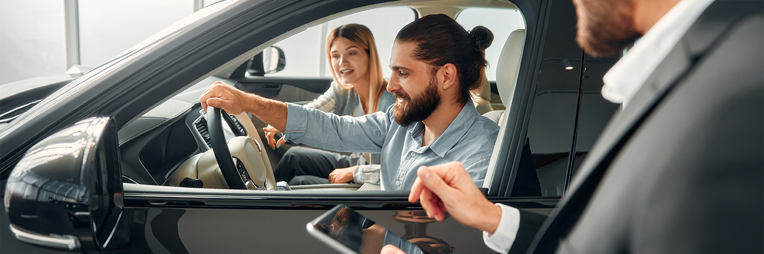 Couple in car at dealership